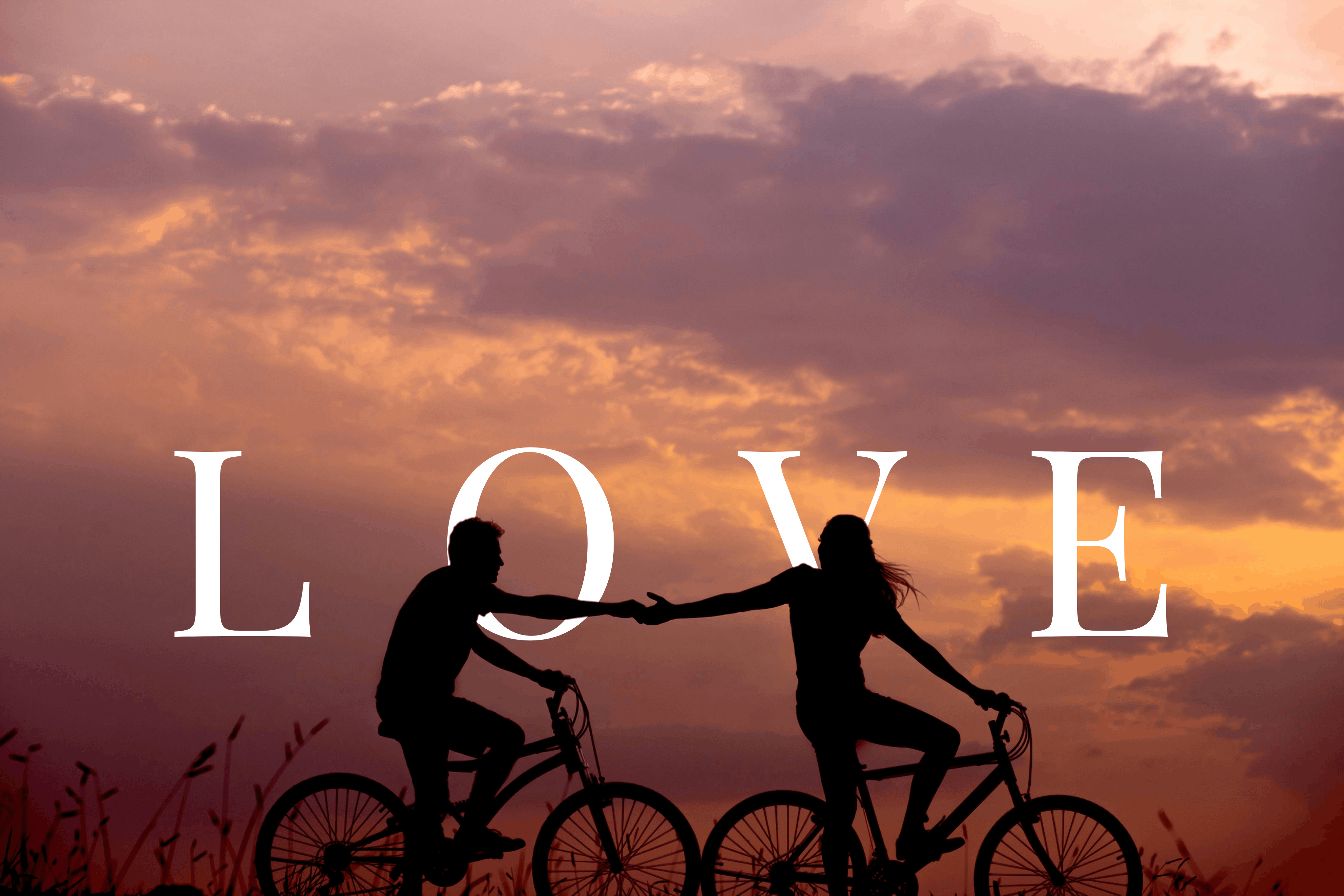 Text behind image effect — LOVE text placed behind a couple on bicycles at sunset